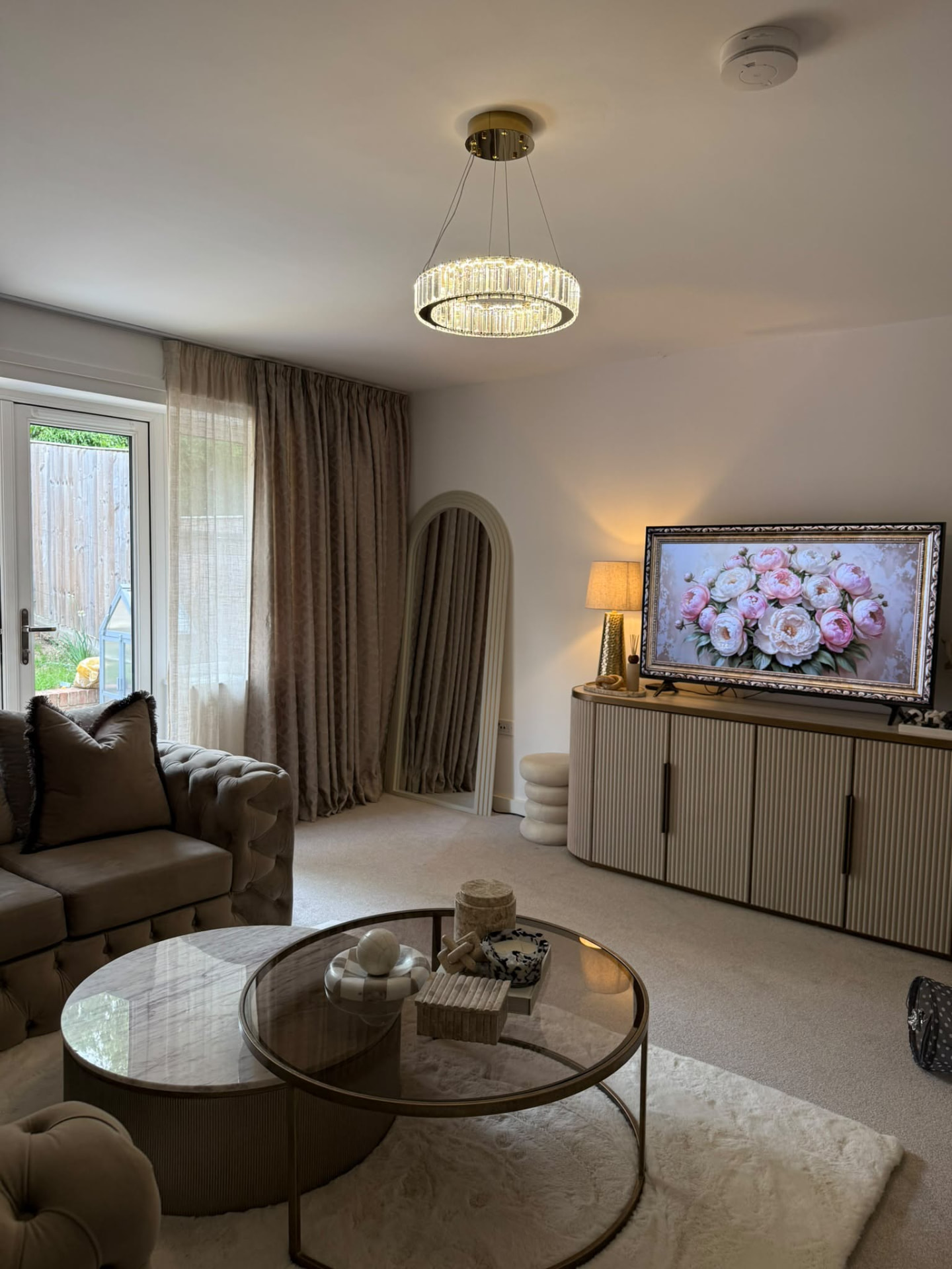 Finished living room with layered neutral textures and brass details